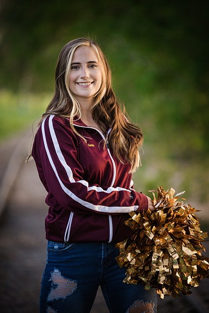 Moses Lake High School senior Tessa Pyle holds her pom poms from the high school drill team for a senior photo shoot.