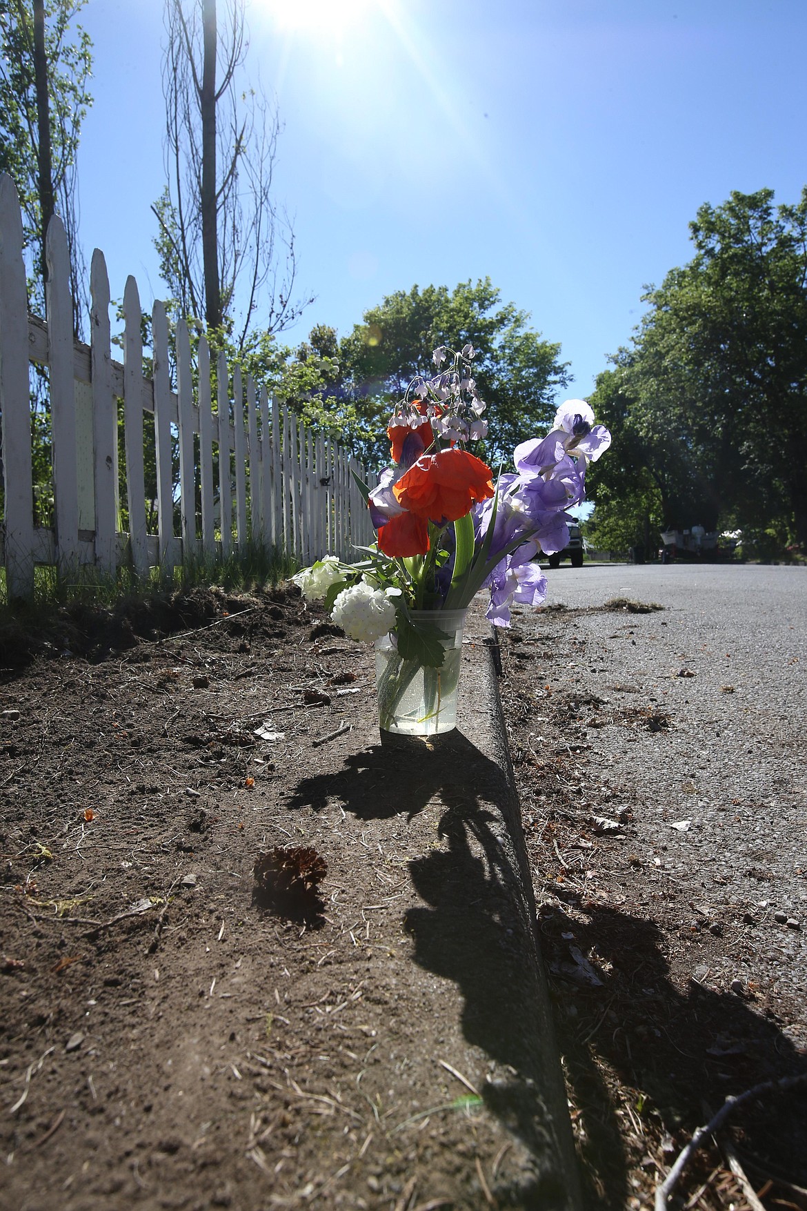 Flowers mark the place where Coeur d’Alene police responded after a man was fatally shot Sunday evening. KAYE THORNBRUGH/Press