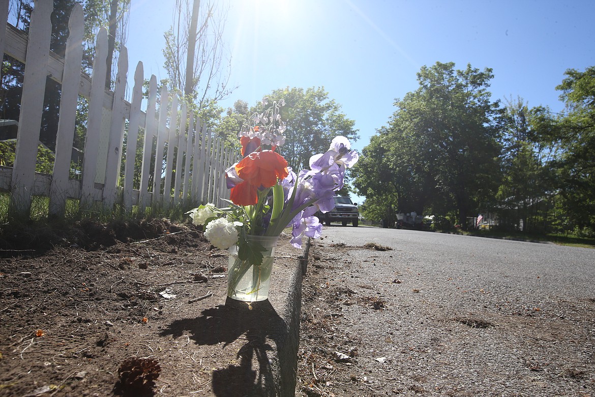 Flowers mark the place where Coeur d’Alene police responded after a man was fatally shot Monday evening. KAYE THORNBRUGH/Press