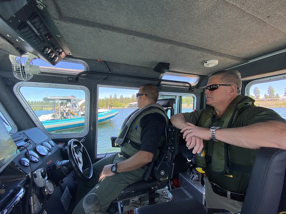 Kootenai County Sheriff Bob Norris, right, and Recreation Safety Supervisor Sgt. Ryan Miller check on a KCSO Marine Divison patrol unit Sunday afternoon. (MADISON HARDY/Press)