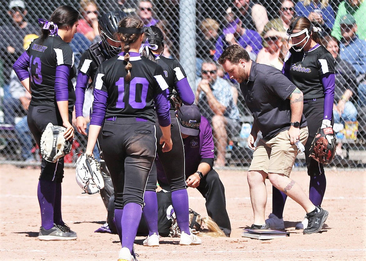 Polson head coach Jami Hanson tends to pitcher Katelyne Druyvestein after she was hit in the knee by a line drive during the state title game against Frenchtown. (Courtesy of Bob Gunderson)