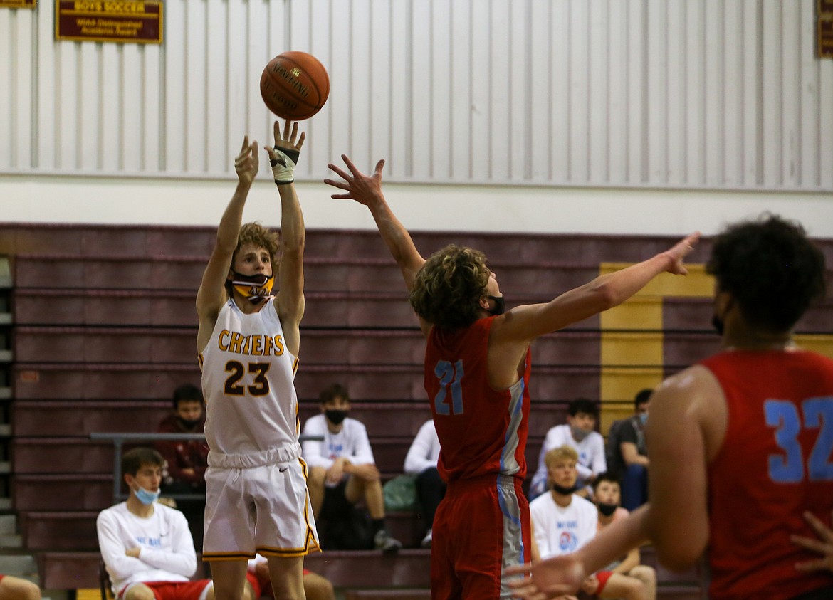 Moses Lake High School's Blaine Macdonald shoots the three from in front of the West Valley High School bench on Tuesday evening in Moses Lake.