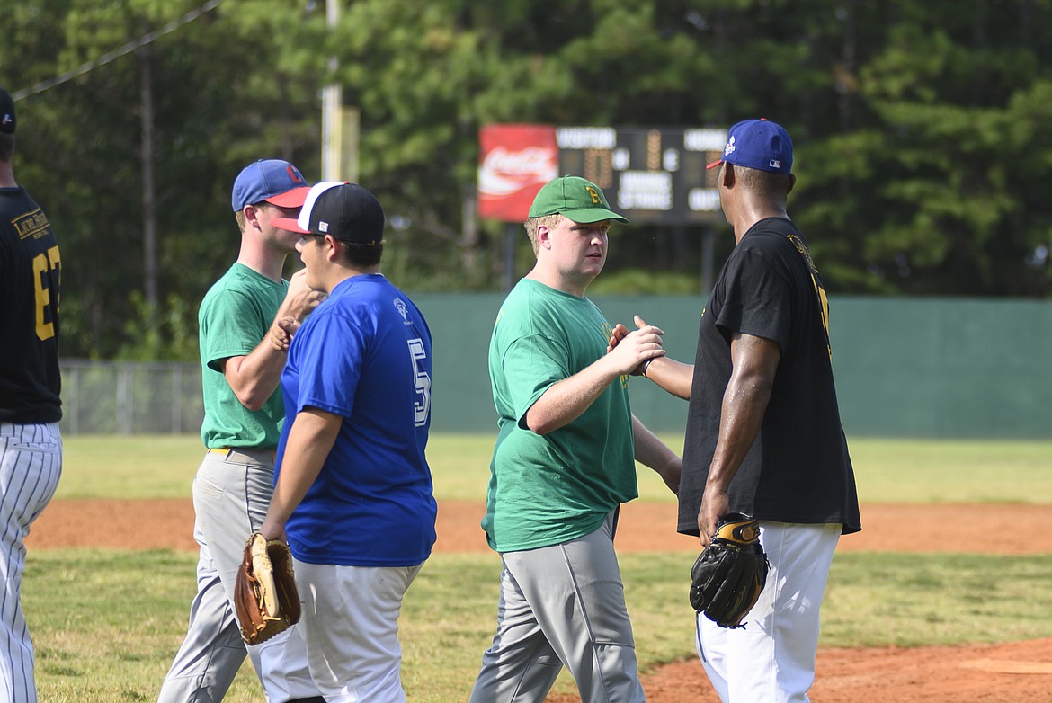 Alternative Baseball Organization players, including Commissioner Taylor Duncan (second from right, in green) high-five retired Major League Baseball pros during the All-Star game.