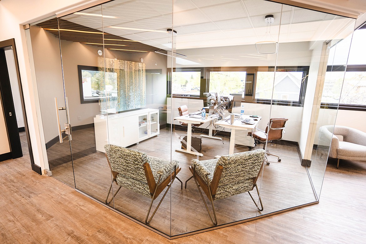 A glass-encased private office is pictured at Atrium Cowork.