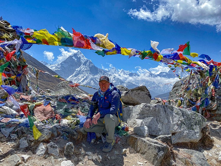 Steve Stevens stops for a quick photo with Mt. Everest in the background on his way to Base Camp. (Photo courtesy of Steve Stevens)