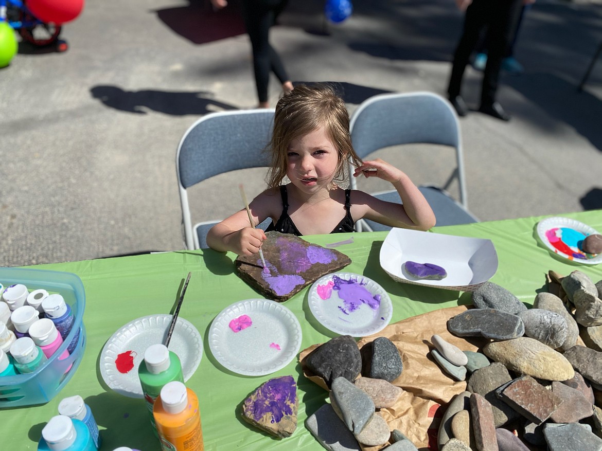 A little girl pants rocks at the Hope Preschool family day event.