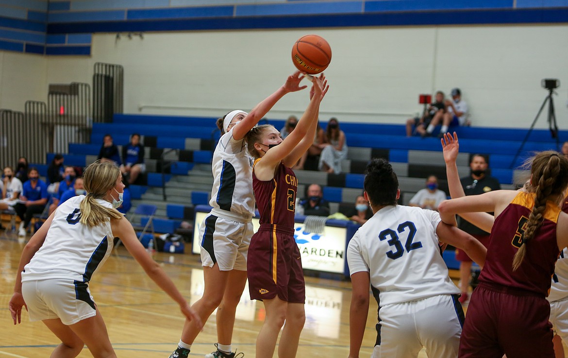 Warden High School's Quinn Erdmann goes up to get a hand on the shot of Moses Lake's Teagan Wiltbank on Wednesday night in Warden.