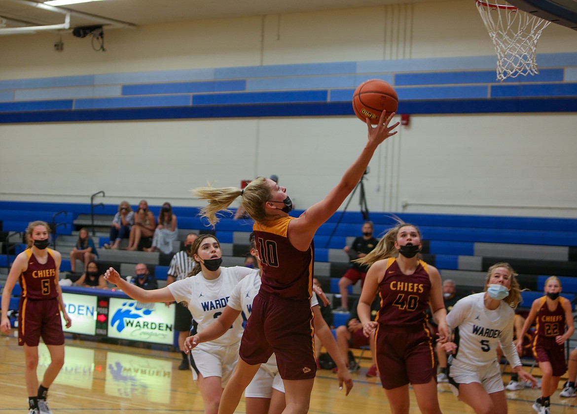 Moses Lake High School's Anna Olson soars into the lane for a layup in the 78-52 defeat at Warden High School against the Cougars on Wednesday.