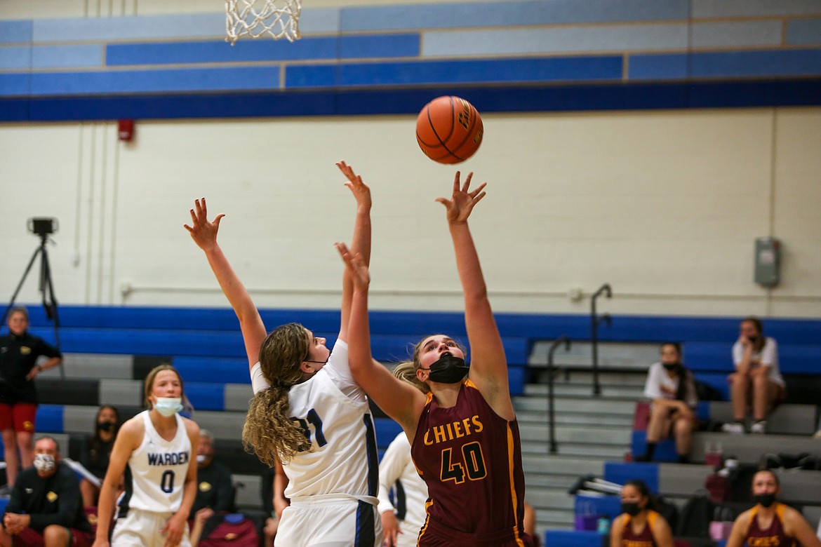 Moses Lake High School senior Meagan Karstetter gets the shot up under the rim with Warden's Rylee McKay contesting on Wednesday night at Warden High School.