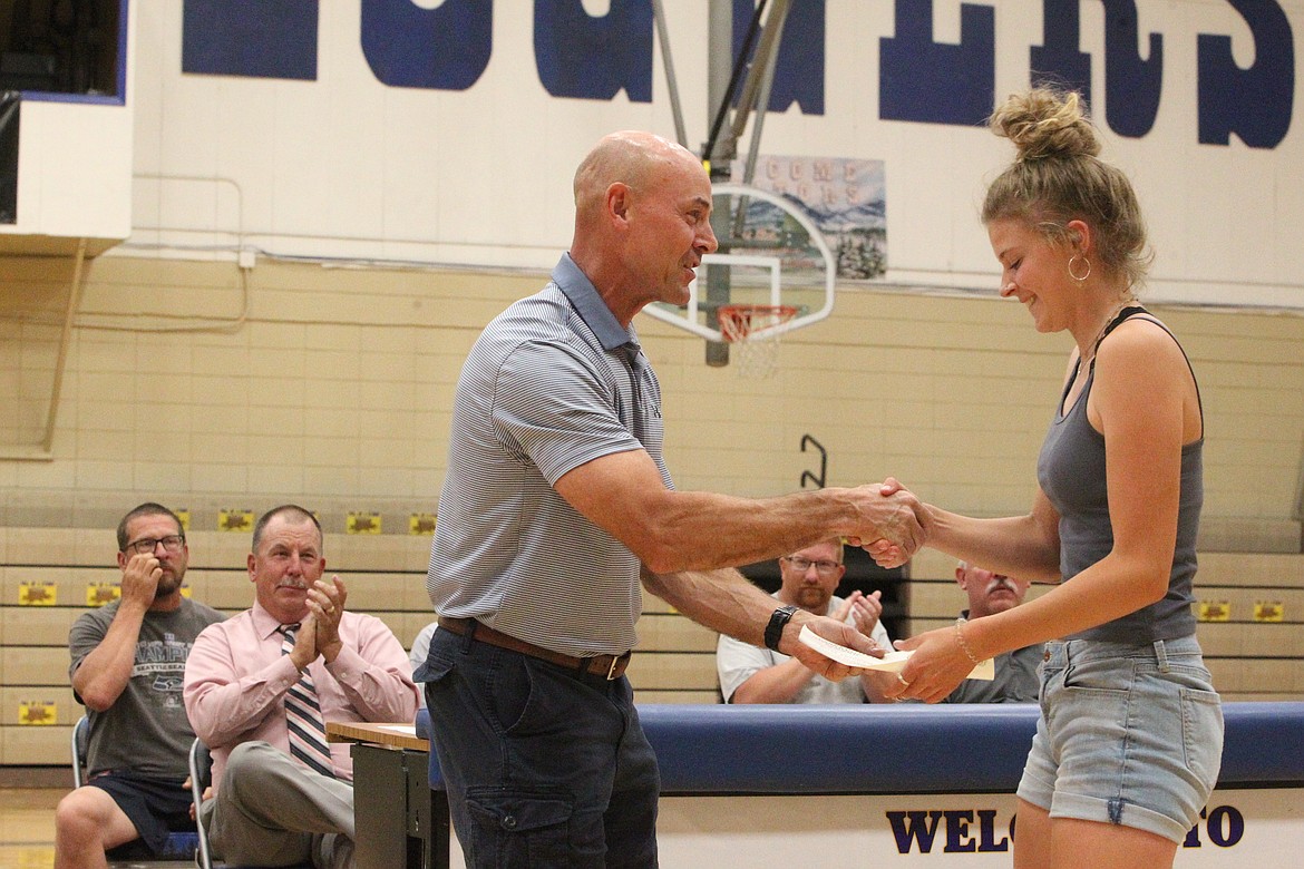 Briann Fruit awards Elise Erickson the Kerry Fruit award during Libby's June 2 sports banquet. (Will Langhorne/The Western News)
