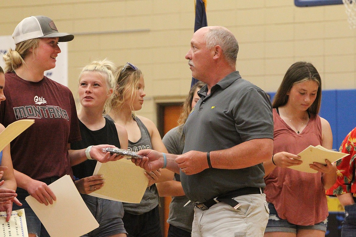 Softball coach Dean Thompson awards Taylor Munro during Libby Middle High School's June 2 sports banquet. Munro won most valuable player on the softball team and was selected first team all-conference and all-state. Munro was also inducted into the Logger Hall of Fame along with Jay Beagle, Ryker McElmurry, Dawson Young and Caden Williams. (Will Langhorne/The Western News)