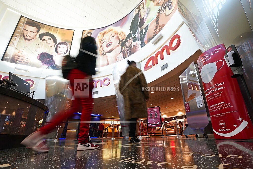 FILE - In this March 15, 2021, file photo movie patrons arrive to see a film at the AMC 16 theater in Burbank, Calif. AMC is looking to sell up to 11.5 million of its shares, as the movie theater operator looks to capitalize on its meme stock popularity. The announcement in a regulatory filing on Thursday, June 3 comes just two days after the company said it was raising $230.5 million through an 8.5 million share sale. (AP Photo/Mark J. Terrill, File)