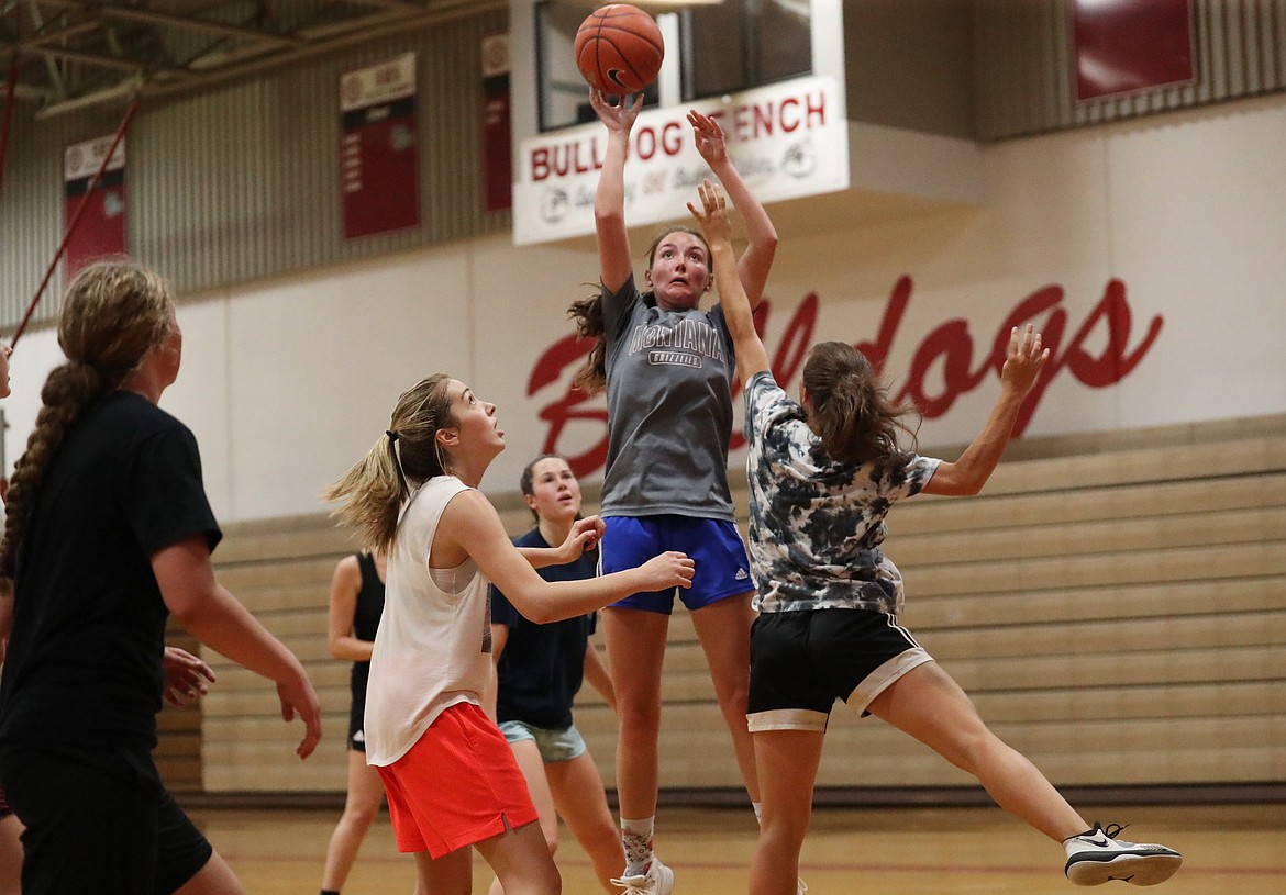 Anna Reinink shoots over a pair of defenders during practice on Thursday.