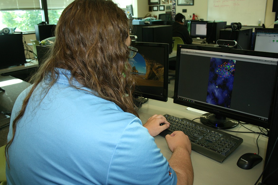 Mikey Ruffle demonstrates the computer game that took third in state FBLA competition. Ruffle and the rest of the team advanced to national competition,