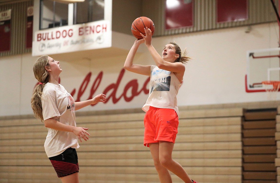 Tru Tomco (right) goes up for a shot over Daylee Driggs during practice on Thursday.