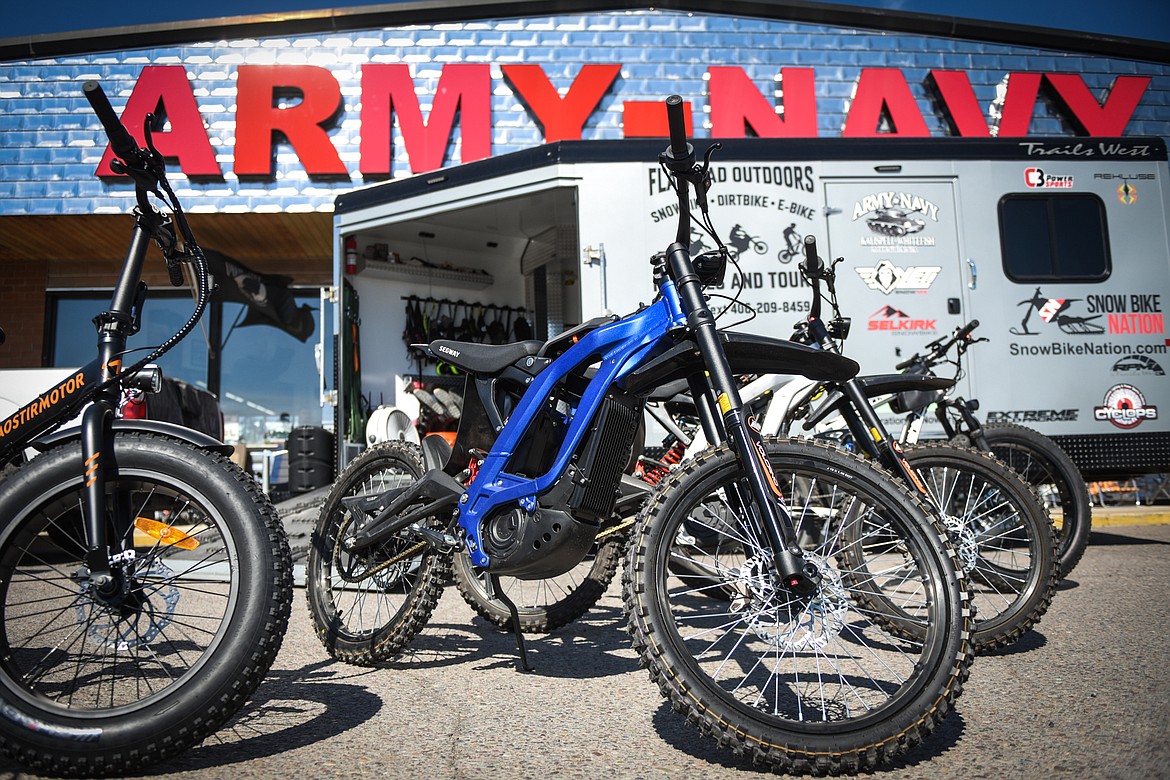 Electric dirtbikes and e-bikes outside the Flathead Outdoors trailer at the Army-Navy store in Evergreen on Friday, June 4. (Casey Kreider/Daily Inter Lake)