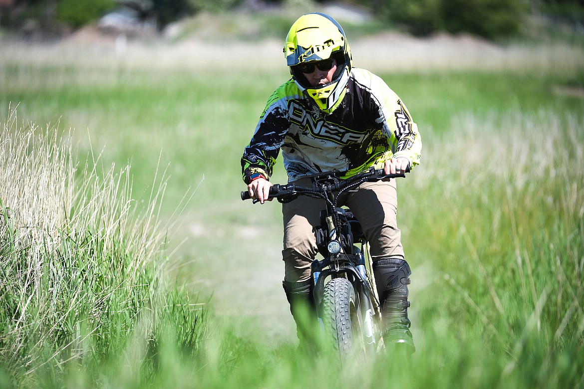 Garren Allred of Flathead Outdoors rides an e-bike in Evergreen on Friday, June 4. (Casey Kreider/Daily Inter Lake)