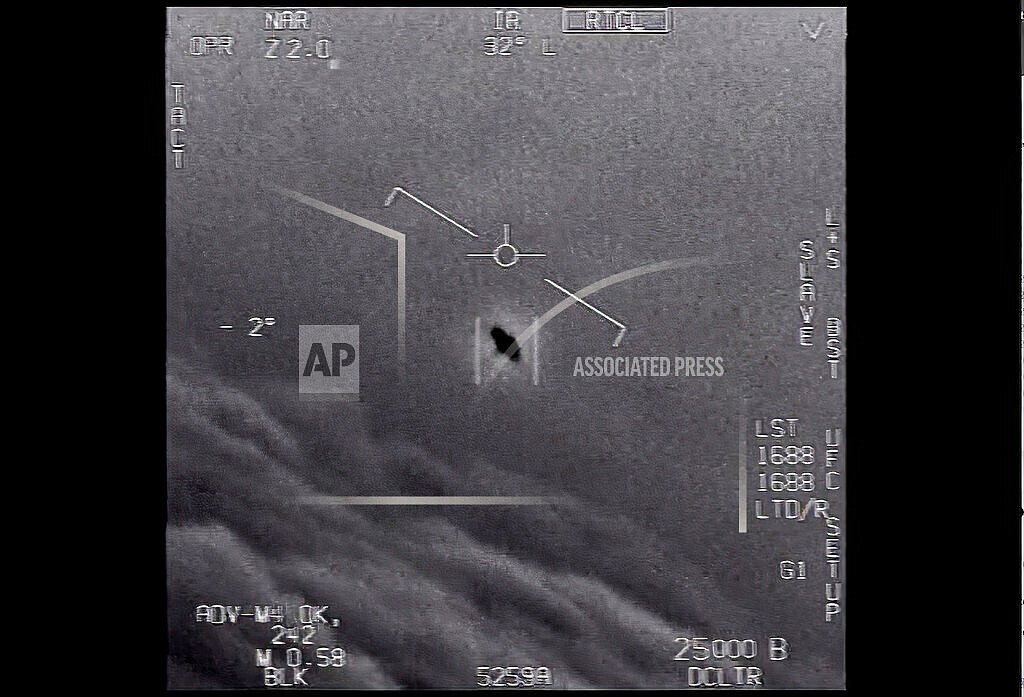 The image from video provided by the Department of Defense labelled Gimbal, from 2015, an unexplained object is seen at center as it is tracked as it soars high along the clouds, traveling against the wind. “There's a whole fleet of them,” one naval aviator tells another, though only one indistinct object is shown. “It's rotating." The U.S. government has been taking a hard look at unidentified flying objects, under orders from Congress, and a report summarizing what officials know is expected to come out in June 2021. (Department of Defense via AP)