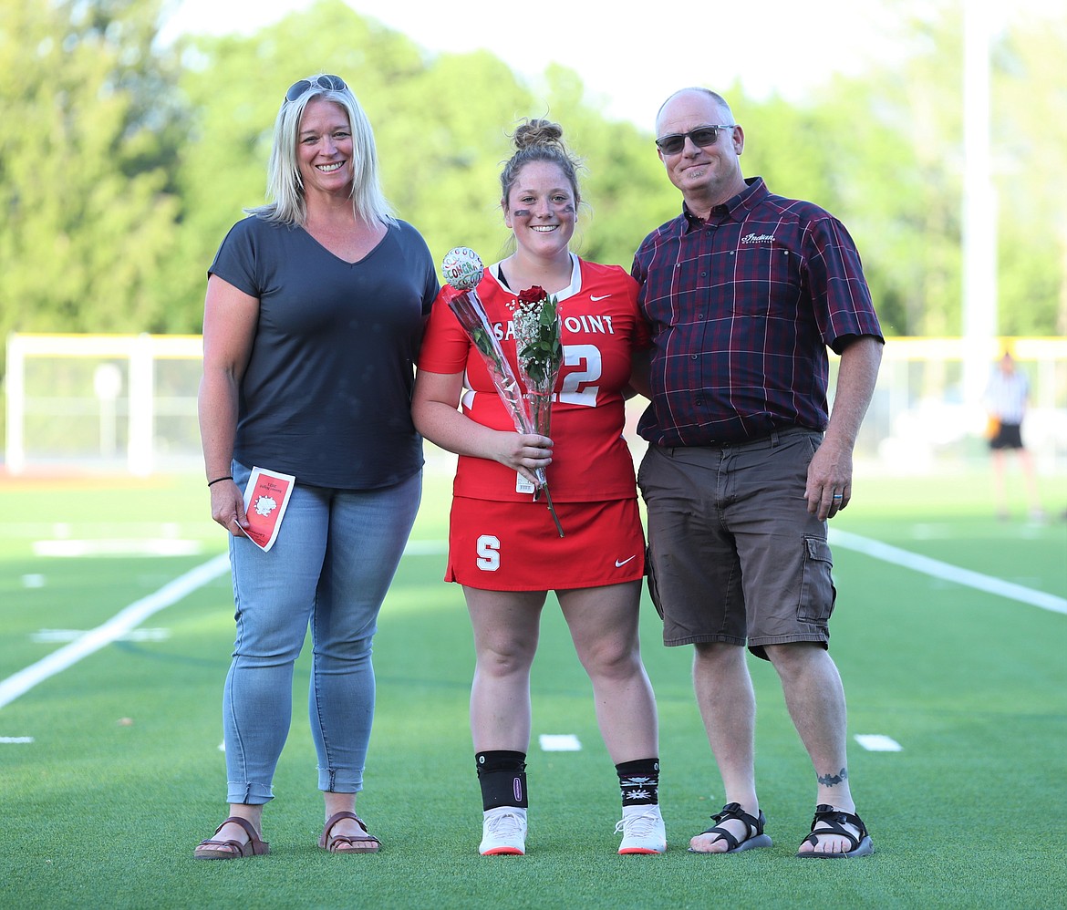 Chandler Sanborn poses for a photo with her family on Senior Night.