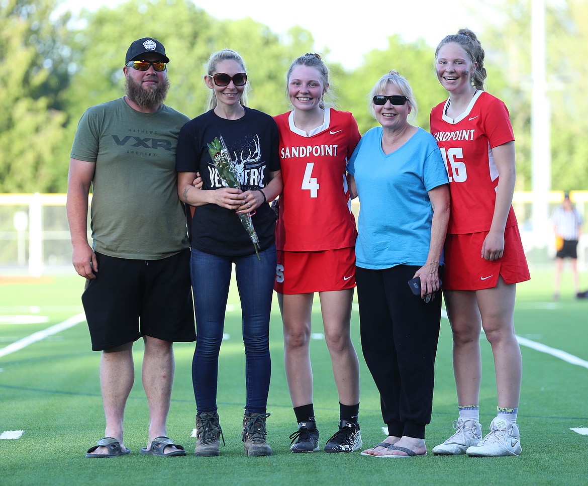 Kaylee Banks poses for a photo with her family on Senior Night.