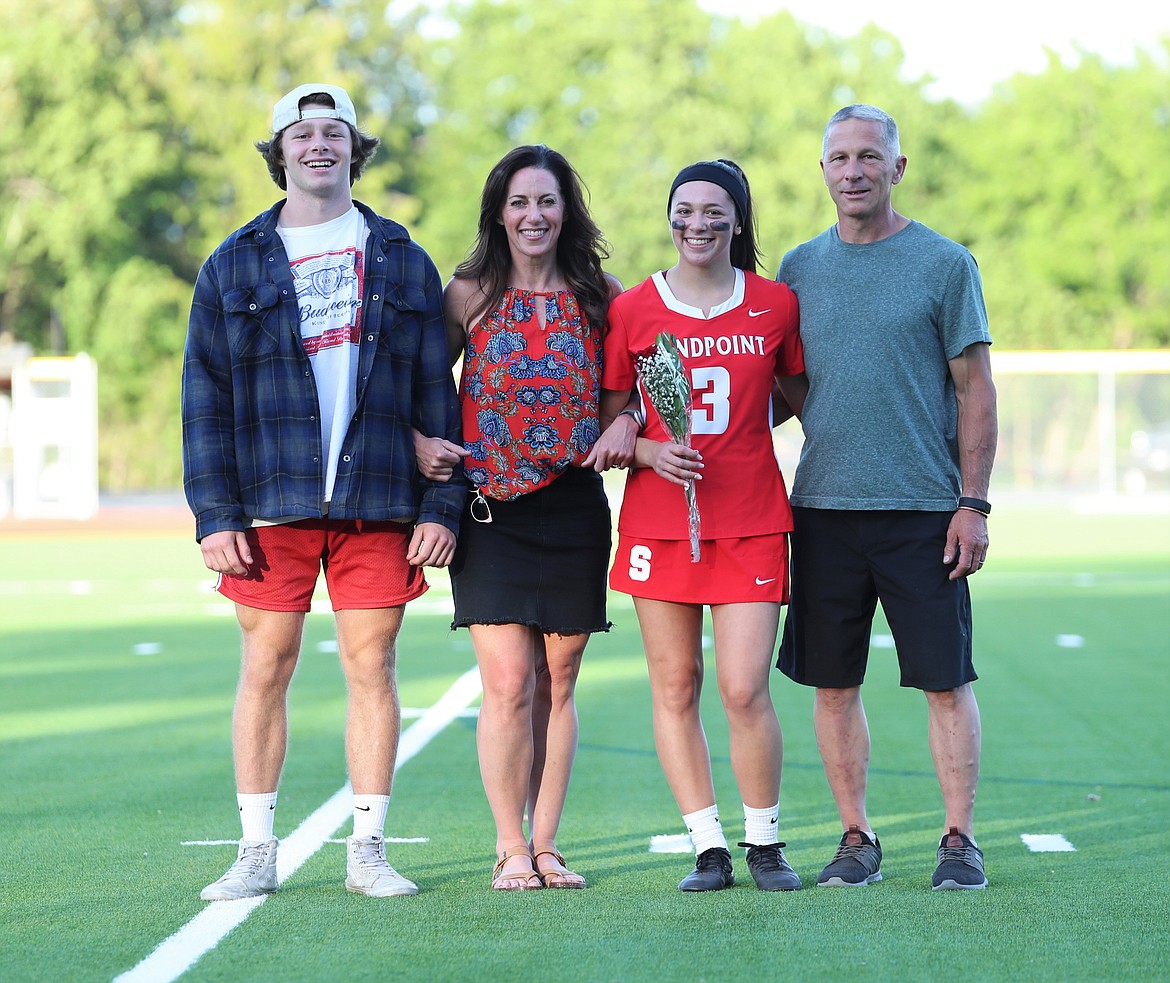 Molly Balison poses for a photo with her family on Senior Night.