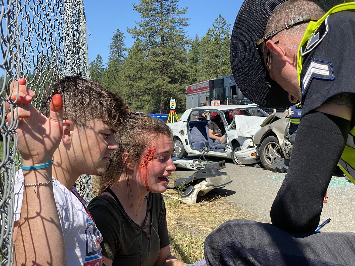 Lakeland High School seniors Colton Dow and Sydnee Hostetler cry out for their friends during a mock DUI performance Friday morning.