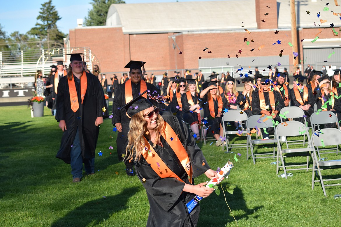 An Ephrata High School senior pops a one-shot confetti cannon during the procession at Friday’s EHS graduation.