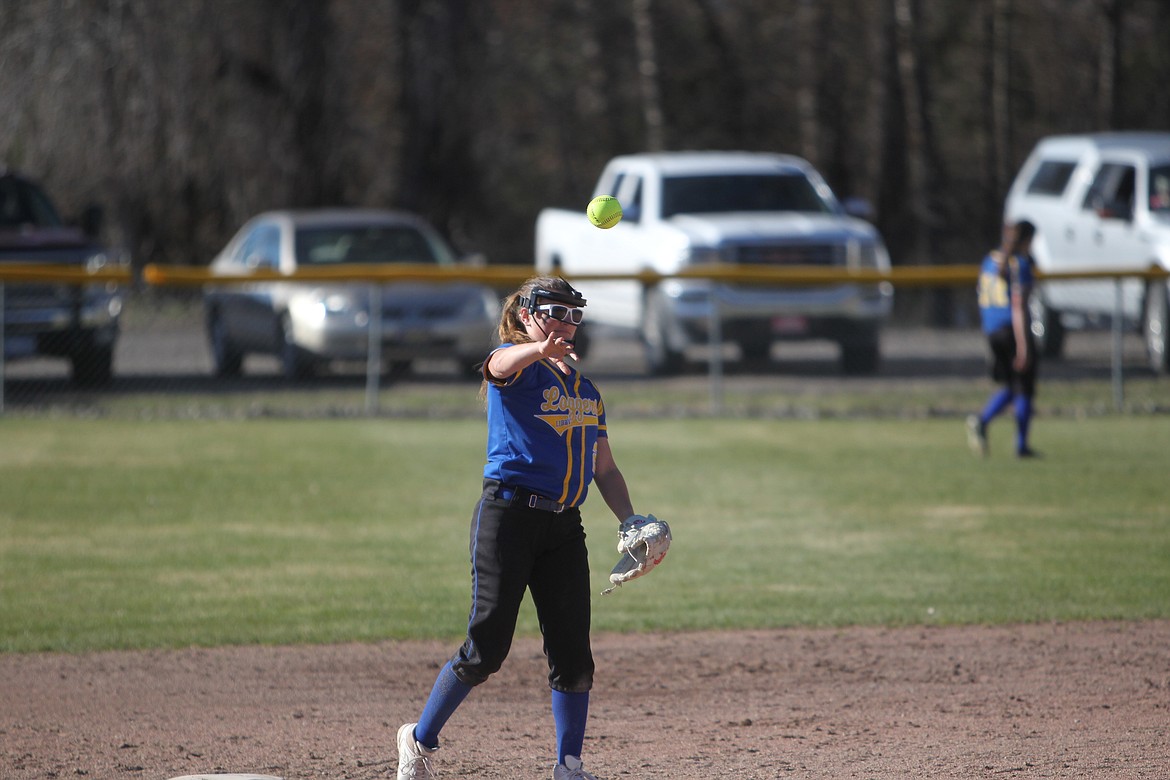 Paislee MacDonald lobs a ball during a Lady Logger game in April. (Will Langhorne/The Western News)