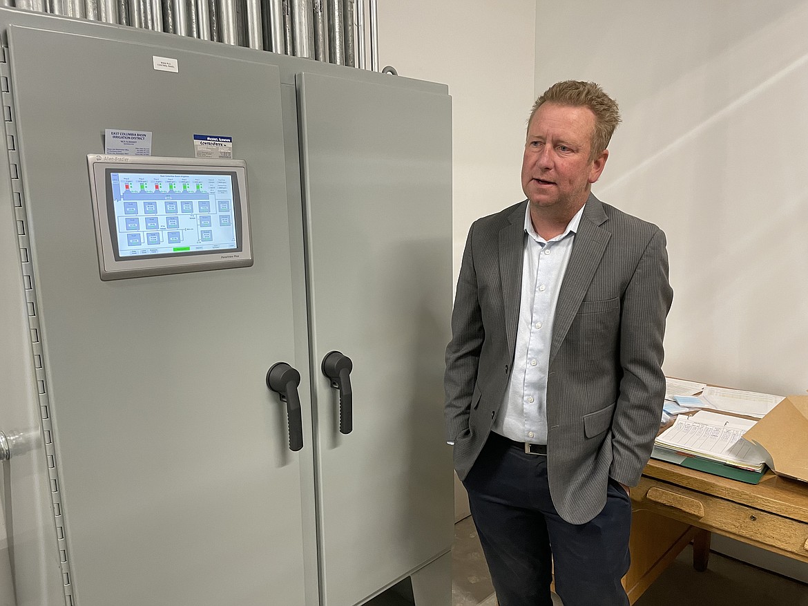 Nate Andreini, assistant manager for technical services for the East Columbia Basin Irrigation District, in front of the switch box and control panel that runs the EL 47.5 pump house.