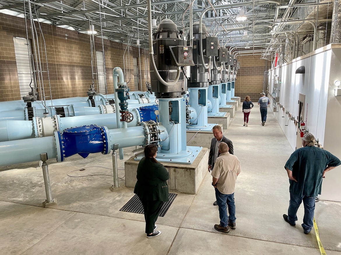 Visitors examine the six huge pumps, all of which run of 1,200 revolutions per minute, inside the EL 47.5 pump house that pump water from the East Low Canal.