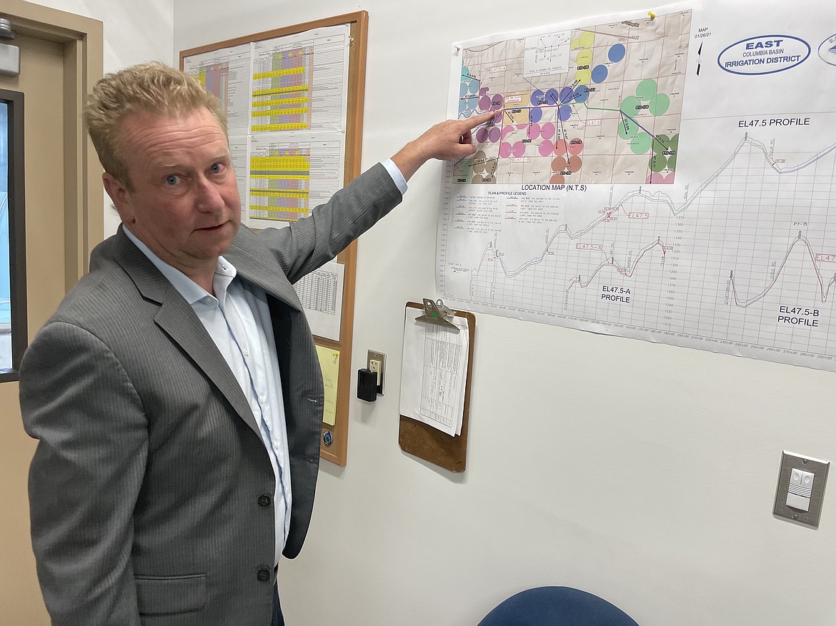 Nate Andreini, assistant manager for technical services for the East Columbia Basin Irrigation District, points out how the EL 47.5 distribution works on a map located in the control room of the EL 47.5 pump house.