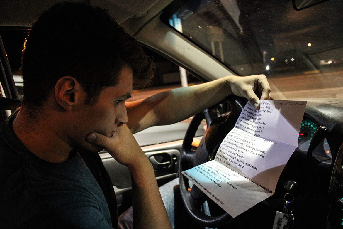 Moses Lake Christian Academy graduate Braden Hunt reads a clue for the senior night scavenger hunt.