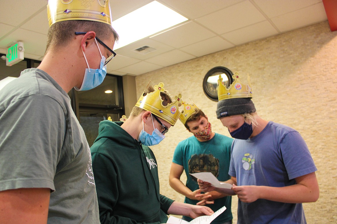 The Moses Lake Christian Academy graduating class deciphers a clue given to them by a Burger King cashier for the senior night scavenger hunt.