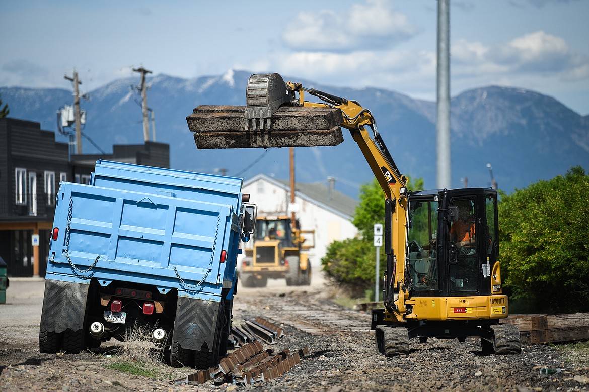 Crews remove railroad ties and sections of track near Fifth Avenue West North to make room for Kalispell's Parkline Trail in this June 1, 2021, file photo. (Casey Kreider/Daily Inter Lake)