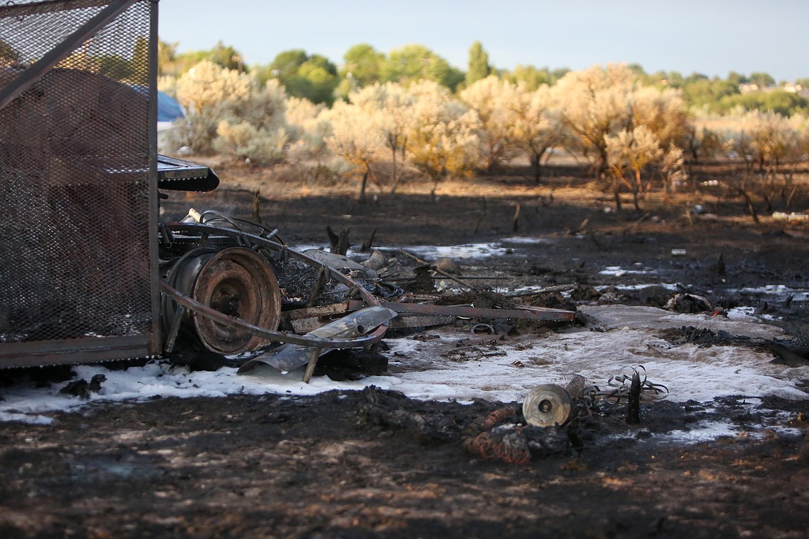 The ground remains charred after a fire sprouted up in a homeless encampment off Kinder Road Northeast in Moses Lake Tuesday.