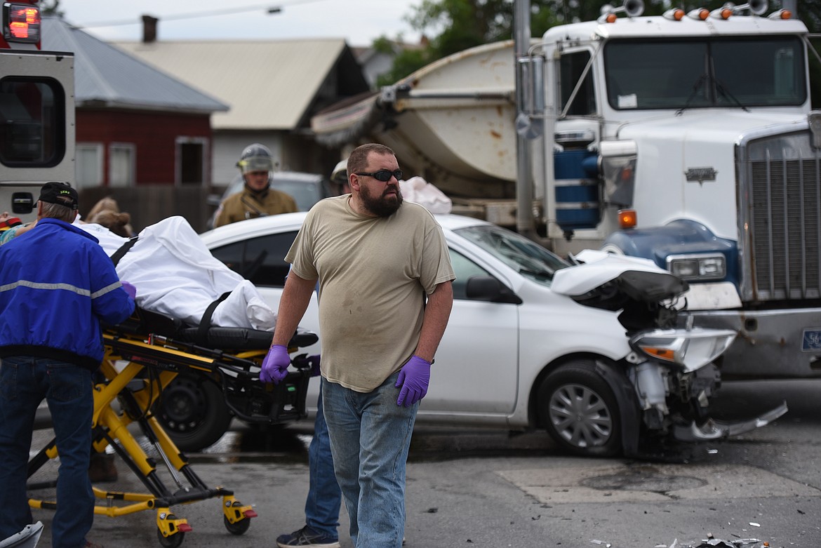 First responders work the scene of a traffic accident near the intersection of U.S. Highway 2 and Minnesota Avenue. (Derrick Perkins/The Western News)