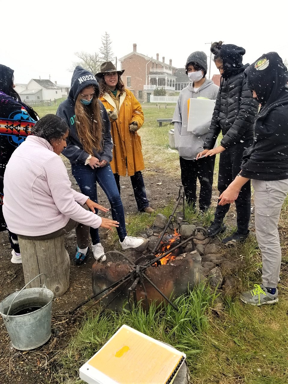 Unseasonably cold weather made the chuckwagon fire at Grant Kohrs Ranch a choice gathering spot for the annual eighth-grade Montana history field tour. (Courtesy of Stacey Doll)