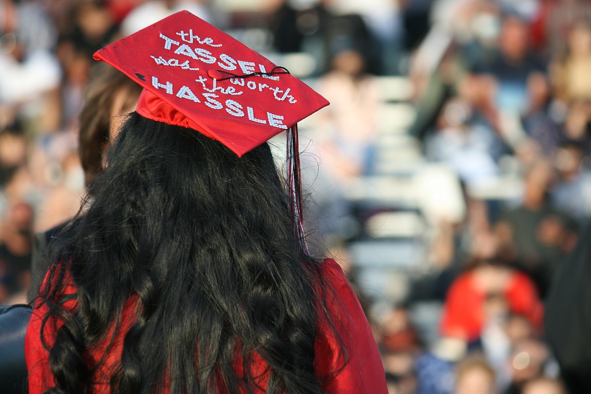 An Othello High School senior uses her cap to express her sentiments during graduation ceremonies June 4.