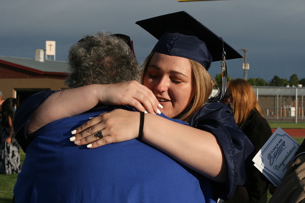 Dejera Conrad hugs her grandmother following Desert Oasis High School graduation ceremonies in Othello June 7.