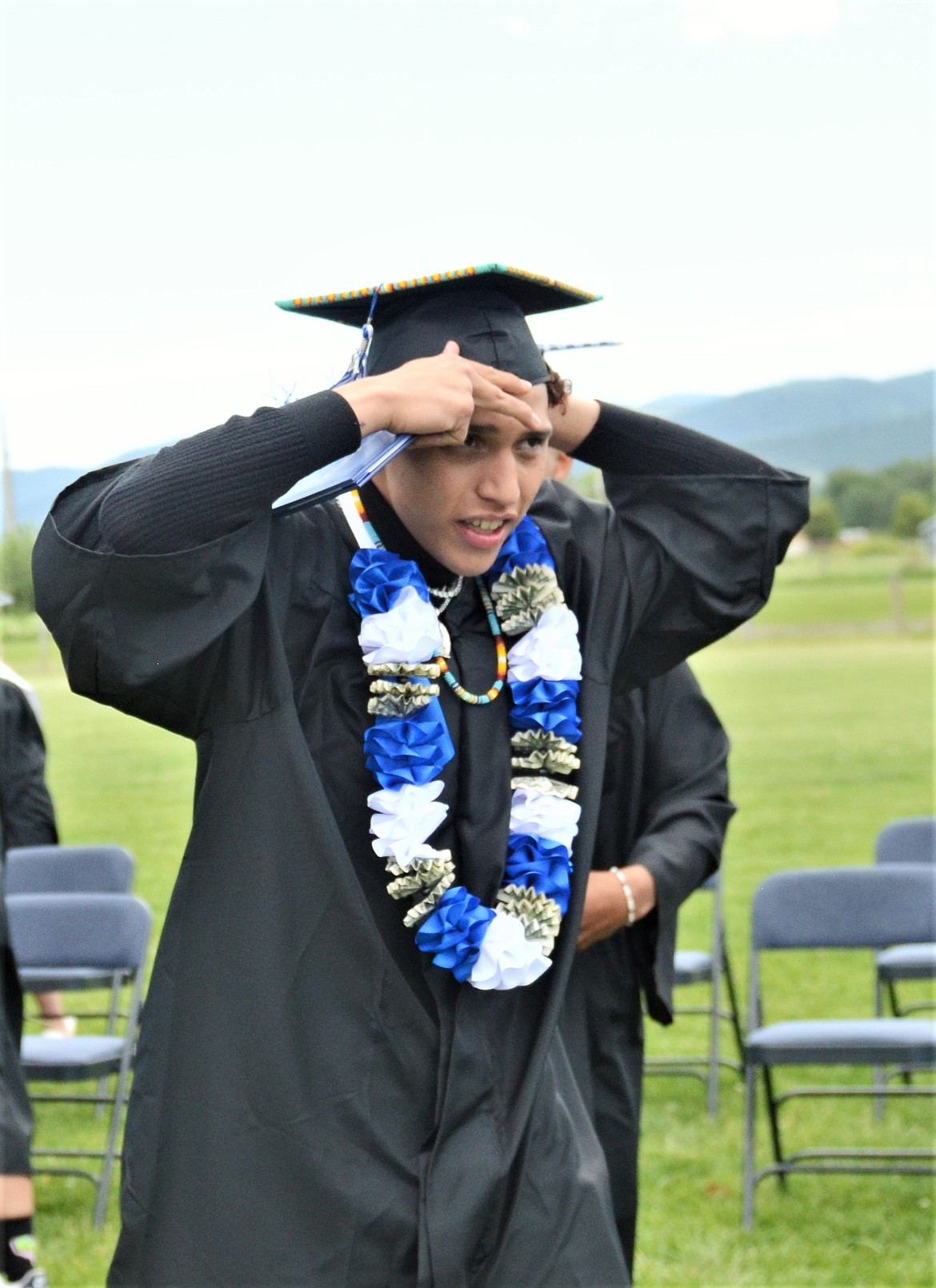 Senior John Komotios adjusts his cap after receiving his diploma Saturday. (Carolyn Hidy/Lake County Leader)