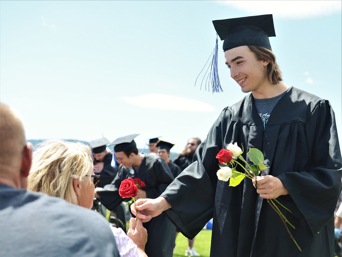 Mission High School seniors handed out roses to thank those who supported them along the way. (Carolyn Hidy/Lake County Leader)