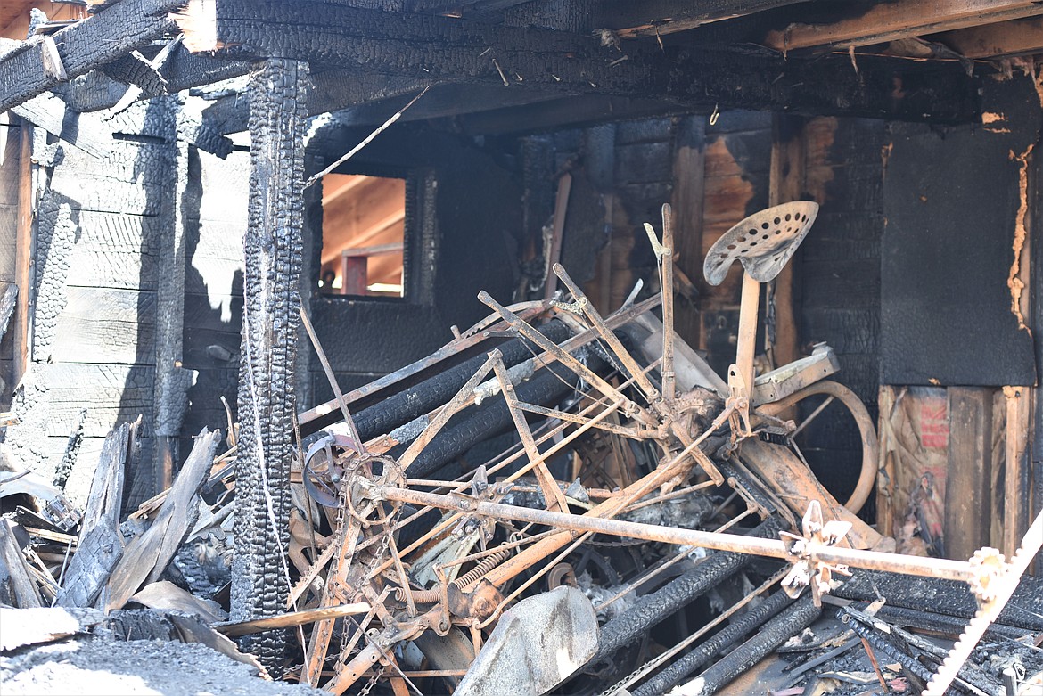 A twisted piece of machinery rests among the ashes of the agriculture barn at the Miracle of America Museum. (Scot Heisel/Lake County Leader)