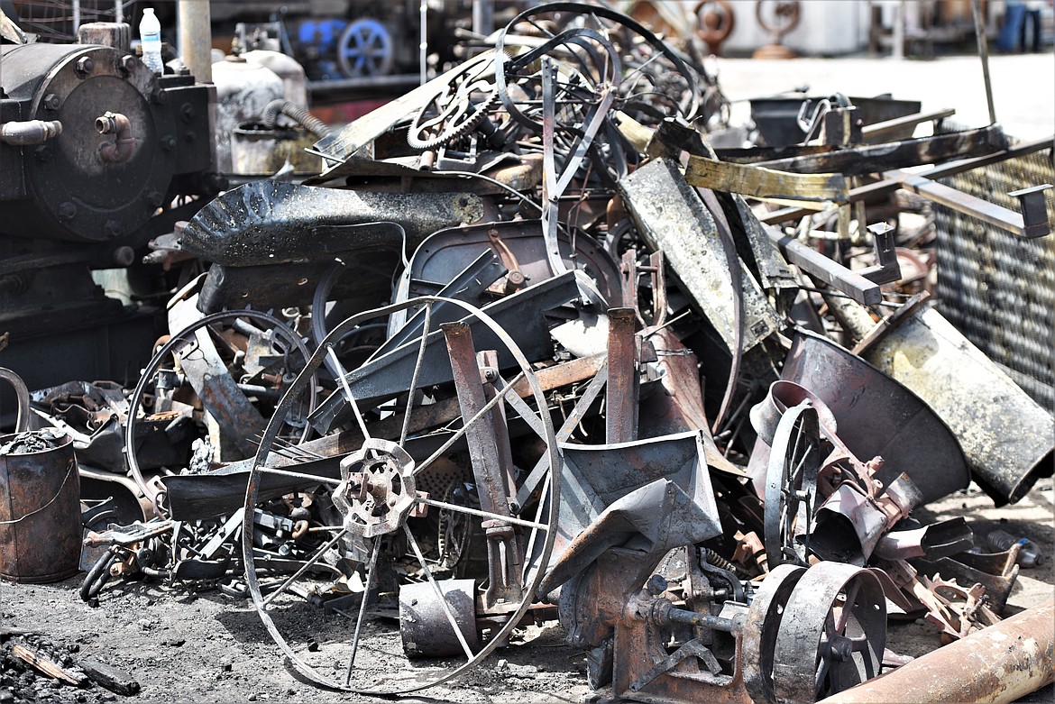 Gil Mangels said he needs to go through several piles of burned museum pieces and determine which are salvageable. He said it will take years to restore everything that wasn't a complete loss. (Scot Heisel/Lake County Leader)