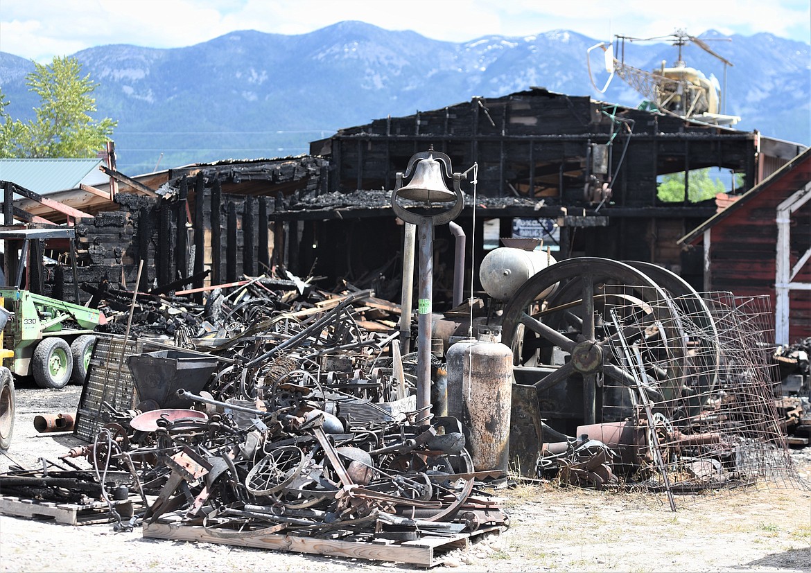 Piles of burned antiques and artifacts stand in front of the burned agriculture barn at the Miracle of America Museum. (Scot Heisel/Lake County Leader)