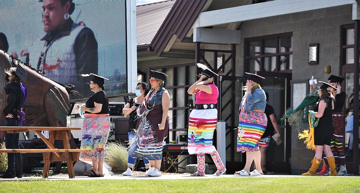 Salish Kootenai College graduates head in single file toward the stage where they received their diplomas and certificates Saturday in Pablo. (Scot Heisel/Lake County Leader)