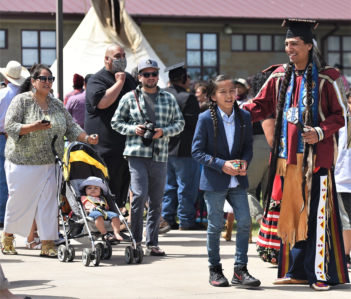 A recent graduate soaks up the day during Saturday's graduation ceremony at Salish Kootenai College in Pablo. (Scot Heisel/Lake County Leader)