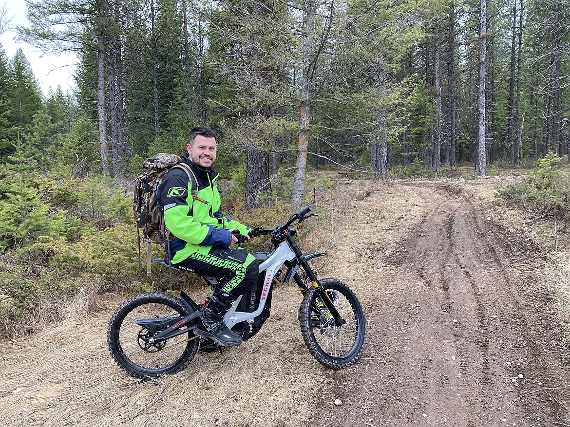 Garren Allred rides an e-dirt bike through the woods (courtesy photo).