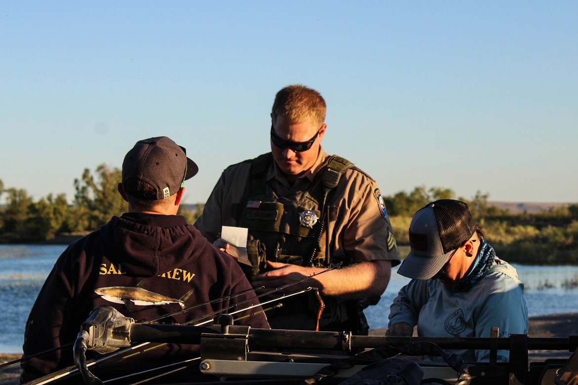 Sgt. Chris Busching checks fishing licenses near Moses Lake.