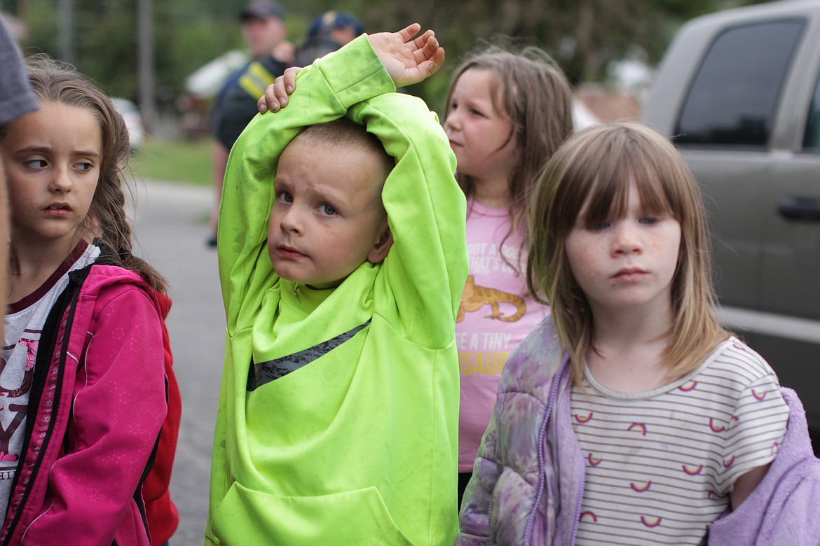 Students raise their hands to ask questions during safety demonstrations Wednesday at Idaho Hill Elementary.