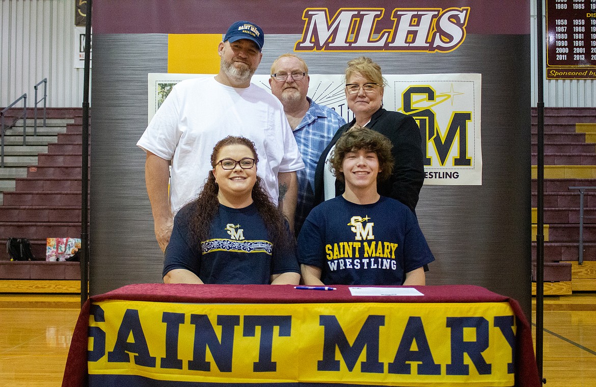 Moses Lake High School's Hunter White, front, is joined by parents, Allison and Jason White, and grandparents, Melisa and Rod White, as he signs with the University of Saint Mary to continue his wrestling career on Thursday afternoon at MLHS.